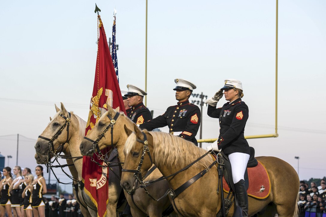 Marines present the U.S. and Marine Corps flags during the playing of the national anthem at a Beech Senior High School football game in Hendersonville, Tenn., Sept. 9, 2016, during Marine Week Nashville. Marine Corps photo by Lance Cpl. Timothy R. Smithers