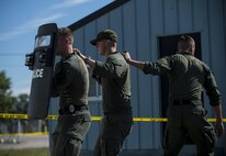A Special Reaction Team from the Military District of Washington moves as a team during a training event in support of Capital Shield 2016 at Fort Belvoir, Virginia, Sept. 14. Approximately 15 U.S. Army Reserve criminal investigative special agents trained alongside 25 active duty agents for the first time in a joint training exercise known as Capital Shield, focusing on crime scene processing, evidence management and hostage negotiations, held Sept. 13-15. The reserve Soldiers participating in this year's Capital Shield are agents from the 733rd Military Police Battalion (Criminal Investigation Division), headquartered in Fort Gillem, Georgia, which reports to the 200th Military Police Command. The active duty agents belong to various offices across the Washington CID Battalion, headquartered at Fort Myer, Virginia. (U.S. Army Reserve photo by Master Sgt. Michel Sauret)