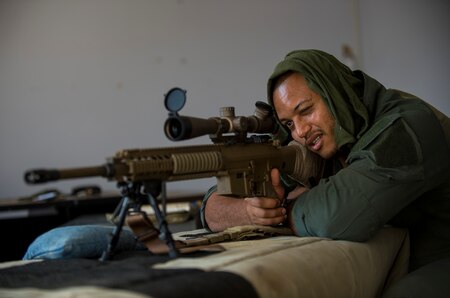 Wes Little, sniper for the Special Reaction Team, Military District of Washington, sets up his firing position in a building in support of Capital Shield 2016 at Fort Belvoir, Virginia, Sept. 14.  Approximately 15 U.S. Army Reserve criminal investigative special agents trained alongside 25 active duty agents for the first time in a joint training exercise known as Capital Shield, focusing on crime scene processing, evidence management and hostage negotiations, held Sept. 13-15. The reserve Soldiers participating in this year's Capital Shield are agents from the 733rd Military Police Battalion (Criminal Investigation Division), headquartered in Fort Gillem, Georgia, which reports to the 200th Military Police Command. The active duty agents belong to various offices across the Washington CID Battalion, headquartered at Fort Myer, Virginia. (U.S. Army Reserve photo by Master Sgt. Michel Sauret)