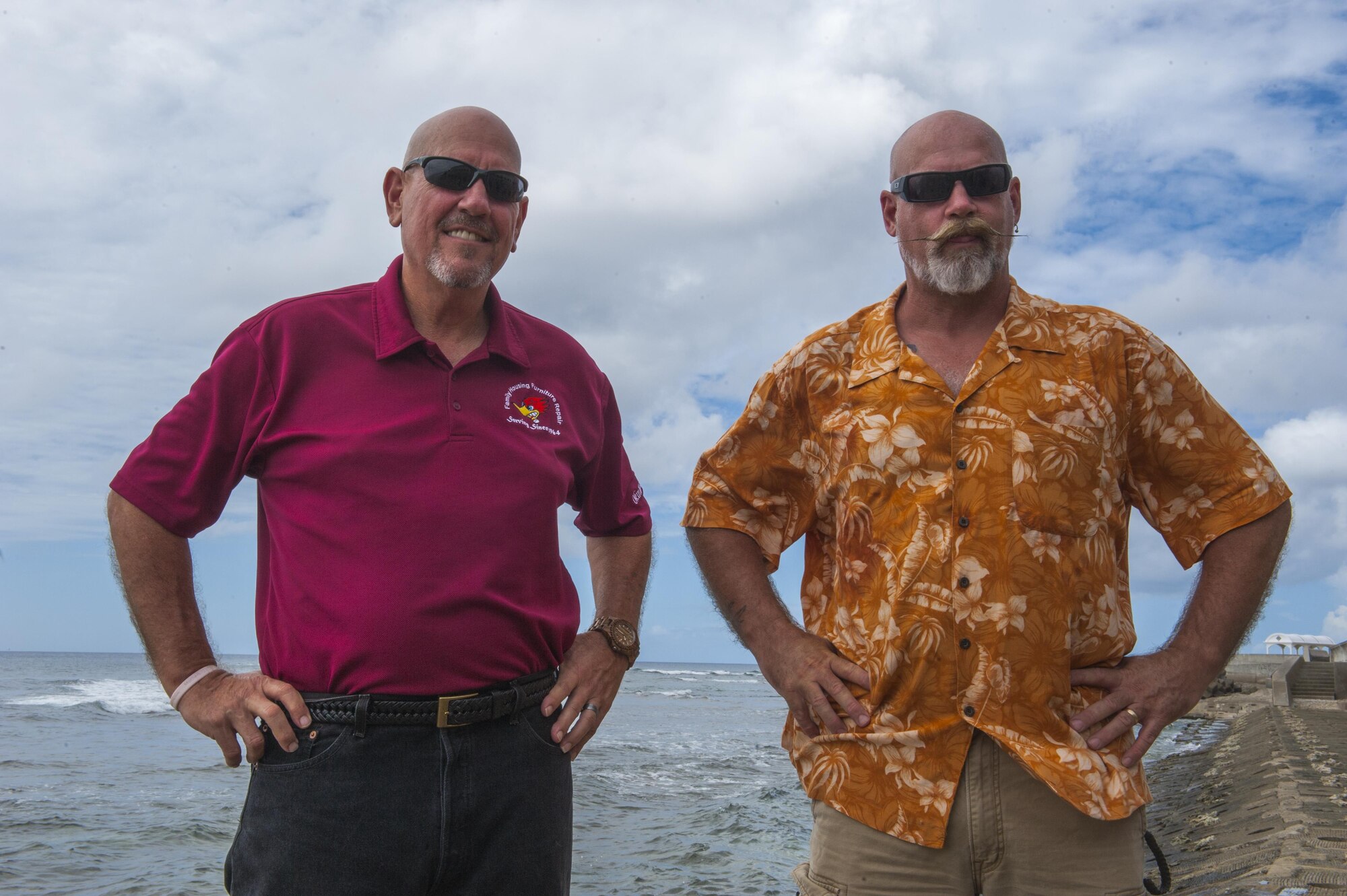 Pat Allbritton and Paul Love, 18th Civil Engineer Group contractors pose for a photo, Aug. 29, 2016, on the Sunabe seawall near Kadena Air Base, Japan. The two rescued a local woman after she had fallen from her surf board and was unable to get out of the water. (U.S. Air Force Photo by Airman 1st Class Nick Emerick)
