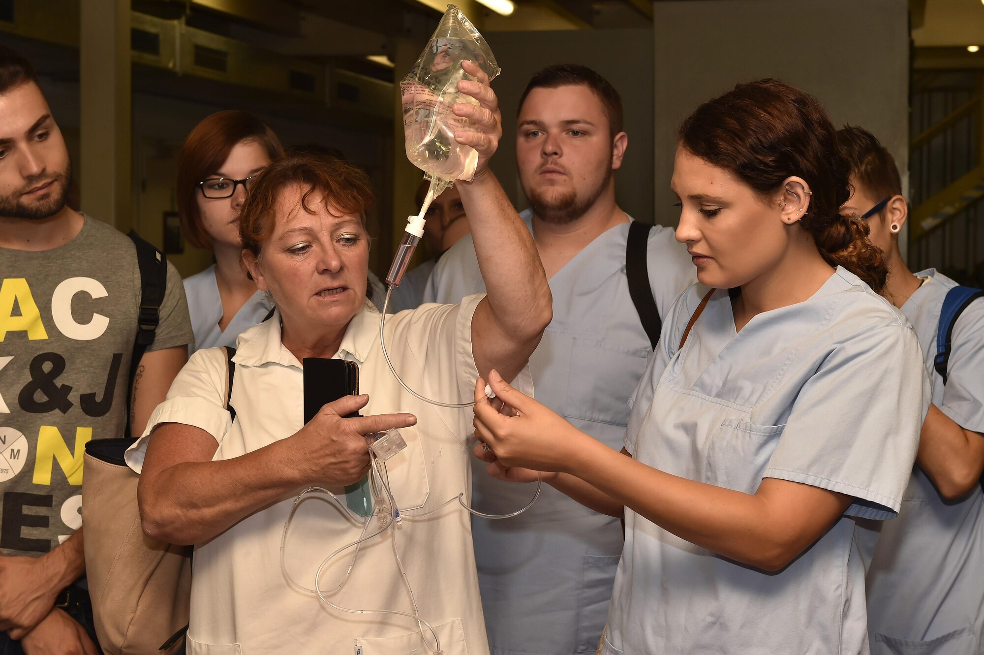 A nursing instructor from Caritas SchulZentrum St. Hildegard, Saarbrücken, Germany, shows her students how American IV’s are set up differently than German IV’s at Ramstein Air Base, Germany, Sept. 13, 2016. Nineteen nursing students toured the 86th Aeromedical Evacuation Squadron’s facilities, learning how Airmen accomplish their mission. (U.S. Air Force photo by Senior Airman Jonathan Bass)
