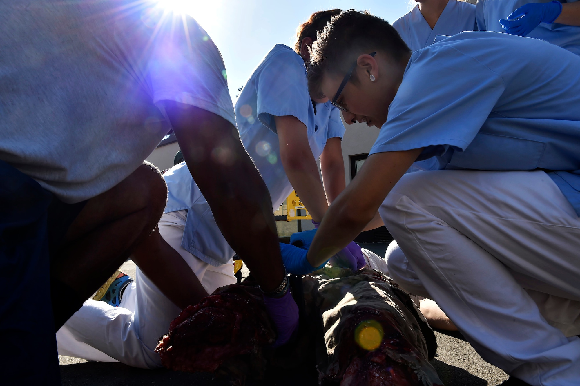 Nursing students from Caritas SchulZentrum St. Hildegard, Saarbrücken, Germany, work with 86th Aeromedical Evacuation Squadron medics in a simulated mass casualty scenario at Ramstein Air Base, Germany, Sept. 13, 2016. The medics and students worked together to triage and treat patients before evacuating them from the scene. (U.S. Air Force photo by Senior Airman Jonathan Bass)
