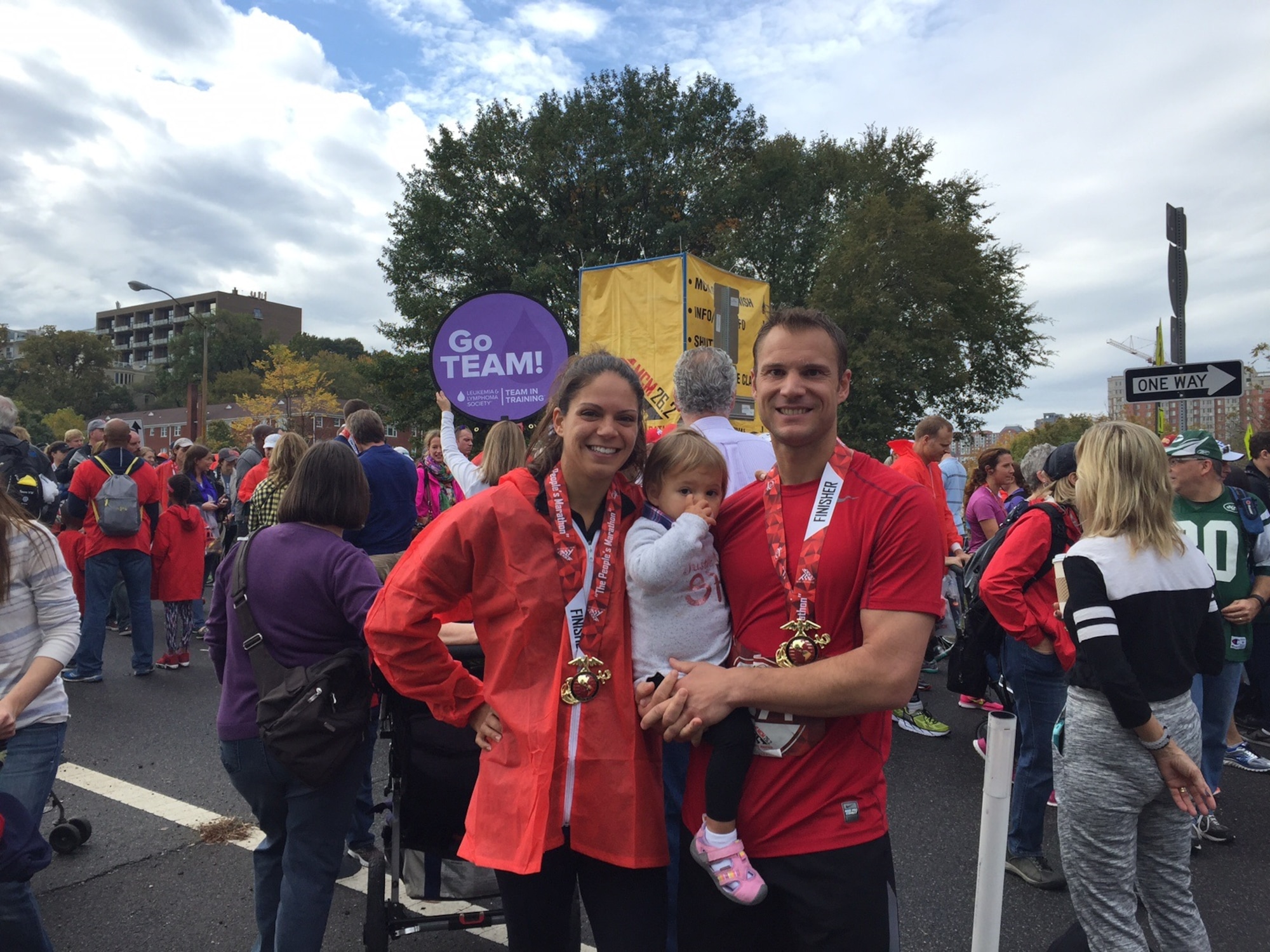 Maj. Lela Diers, chief of plans and programs for the Air Force Element at the Defense Intelligence Agency, stands with her husband Beau and daughter Aria at the finish line of the 2015 Marine Corps Marathon on Oct. 25, in Arlington, Virginia. (courtesy photo)