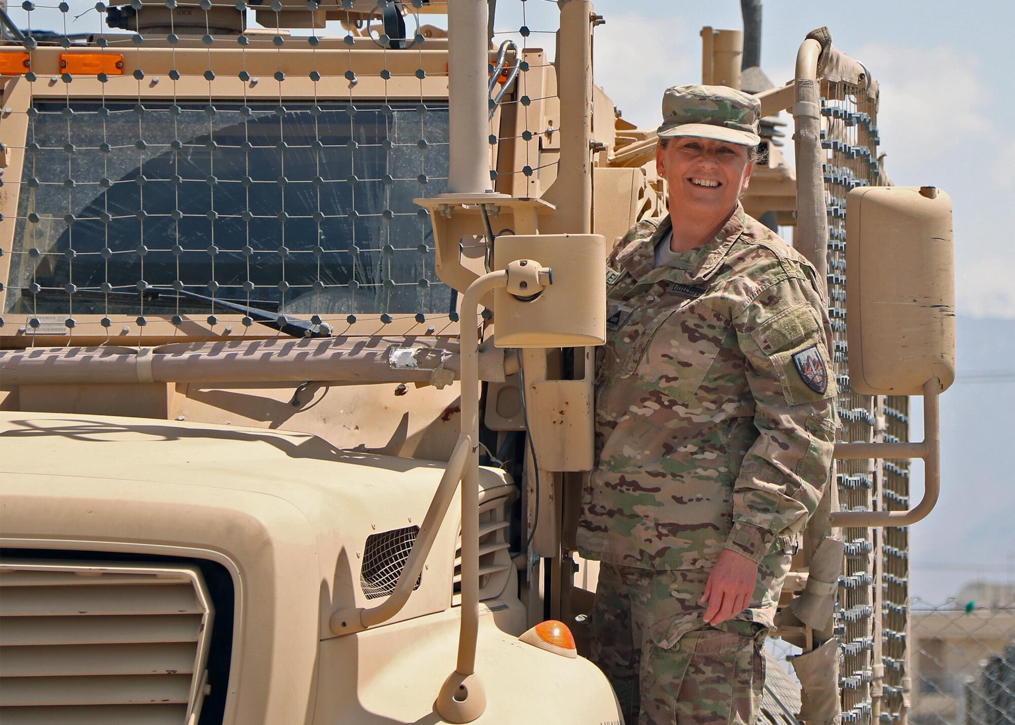 Melissa E. Lewman, the master planning manager and directorate of public works assigned to U.S. Forces-Afghanistan, stands on an armored vehicle at Bagram Airfield (BAF), Afghanistan, May 11, 2016. Lewman was responsible for managing more than 77 high profile projects and overseeing identification and documentation of more than 2,800 properties on BAF. (U.S. Army photo by Jet Fabara) 