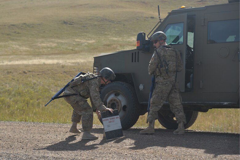 Airmen from the 741st Missile Security Forces Squadron Convoy Response Force cordon off an access road as part of a Local Integrated Response Plan exercise Sept. 14, 2016, near Stanford, Mont.  The LIRP is a generalized plan that coordinates the response capabilities of the Air Force, FBI and civilian law enforcement departments within the state if a nuclear asset were ever threatened or compromised.  (U.S. Air Force photo/Airman First Class Daniel Brosam)