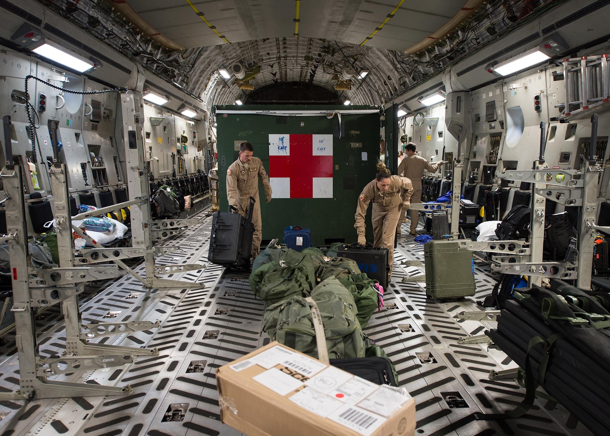 Senior Airman Chris Dale and Tech. Sgt. Erin Morit, 10th Expeditionary Aeromedical Evacuation Flight technicians, load and arrange equipment onto a C-17A Globemaster III at Ramstein Air Base, Germany, Sept. 9, 2016. After being alerted for a mission, members of the 10th EAEF have just hours to report, check equipment, load the plane and set-up for the mission. (U.S. Air Force photo/Senior Airman Jimmie D. Pike)
