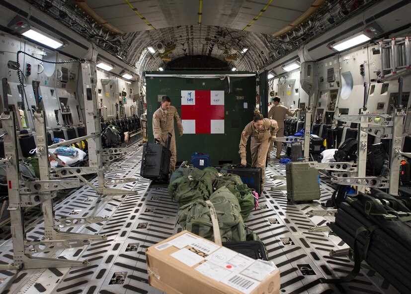 Senior Airman Chris Dale and Tech. Sgt. Erin Morit, 10th Expeditionary Aeromedical Evacuation Flight technicians, load and arrange equipment onto a C-17A Globemaster III at Ramstein Air Base, Germany, Sept. 9, 2016. After being alerted for a mission, members of the 10th EAEF have just hours to report, check equipment, load the plane and set-up for the mission. (U.S. Air Force photo/Senior Airman Jimmie D. Pike)