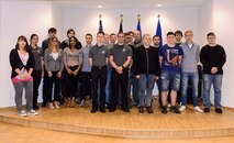 Twenty one local national apprentices, pose for a group photo with Brig. Gen. Richard G. Moore Jr., 86th Airlift Wing commander, during a welcoming event at Ramstein Air Base, Germany, Sept. 16, 2016. The apprentices were hired through Ramstein’s recently revived apprenticeship program. (U.S. Air Force photo/Tech. Sgt. Sara Keller)   