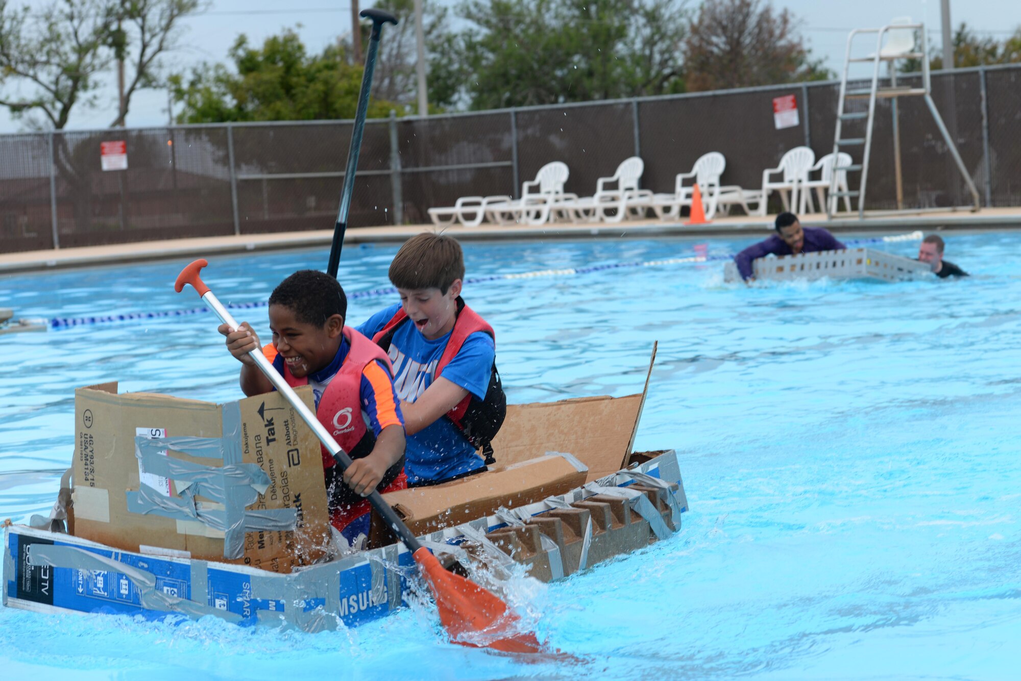 Giovoni Fleurimond, 10 (left), and Cameron Mann, 12, take the lead in the 2016 Cardboard Boat Race on Laughlin Air Force Base, Texas, Sept. 10. Fleurimond and Mann faced off against the 47th Comptroller Squadron finance team and emerged victorious. (U.S. Air Force photo Airman 1st Class Benjamin N. Valmoja)