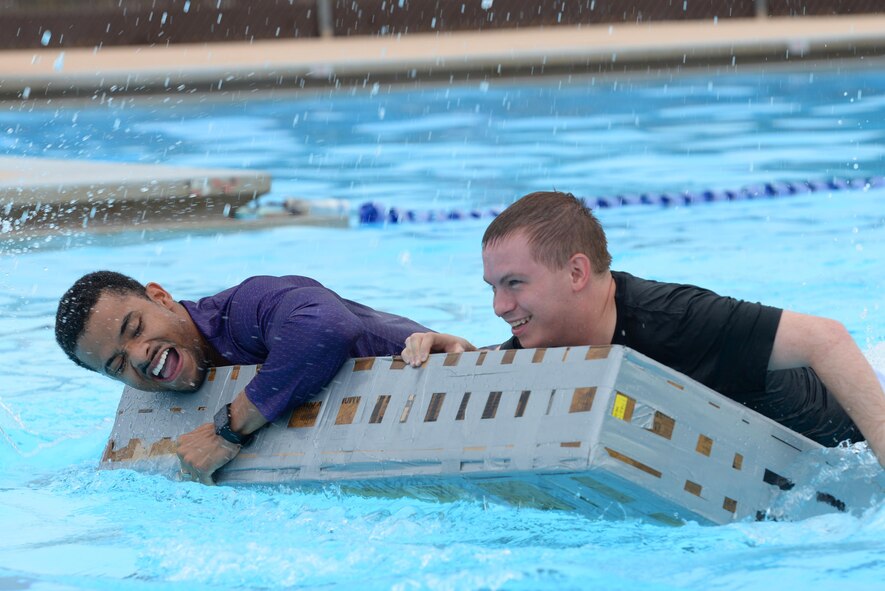Senior Airman Omari Thomas, 47th Comptroller Squadron financial services technician, and Senior Airman Dustin Walls, 47th CPTS financial budget analyst, paddle their ship’s wreckage to the finish line during the 2016 Cardboard Boat Race on Laughlin Air Force Base, Texas, Sept. 10. Although their boat sank during the race, they managed to get the vessel across the finish line. (U.S. Air Force photo/ Airman 1st Class Benjamin N. Valmoja)