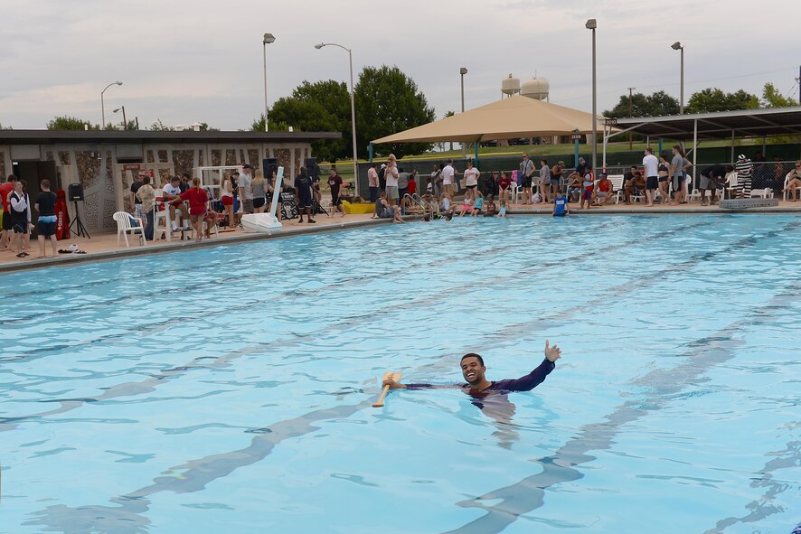 Senior Airman Omari Thomas, 47th Comptroller Squadron financial services technician, retrieves his oar after his boat sank in the 2016 Cardboard Boat Race on Laughlin Air Force Base, Texas, Sept. 10, 2016. Thomas was one of the competitors who designed, built and raced their own vessels against other teams. (U.S. Air Force photo Airman 1st Class Benjamin N. Valmoja)