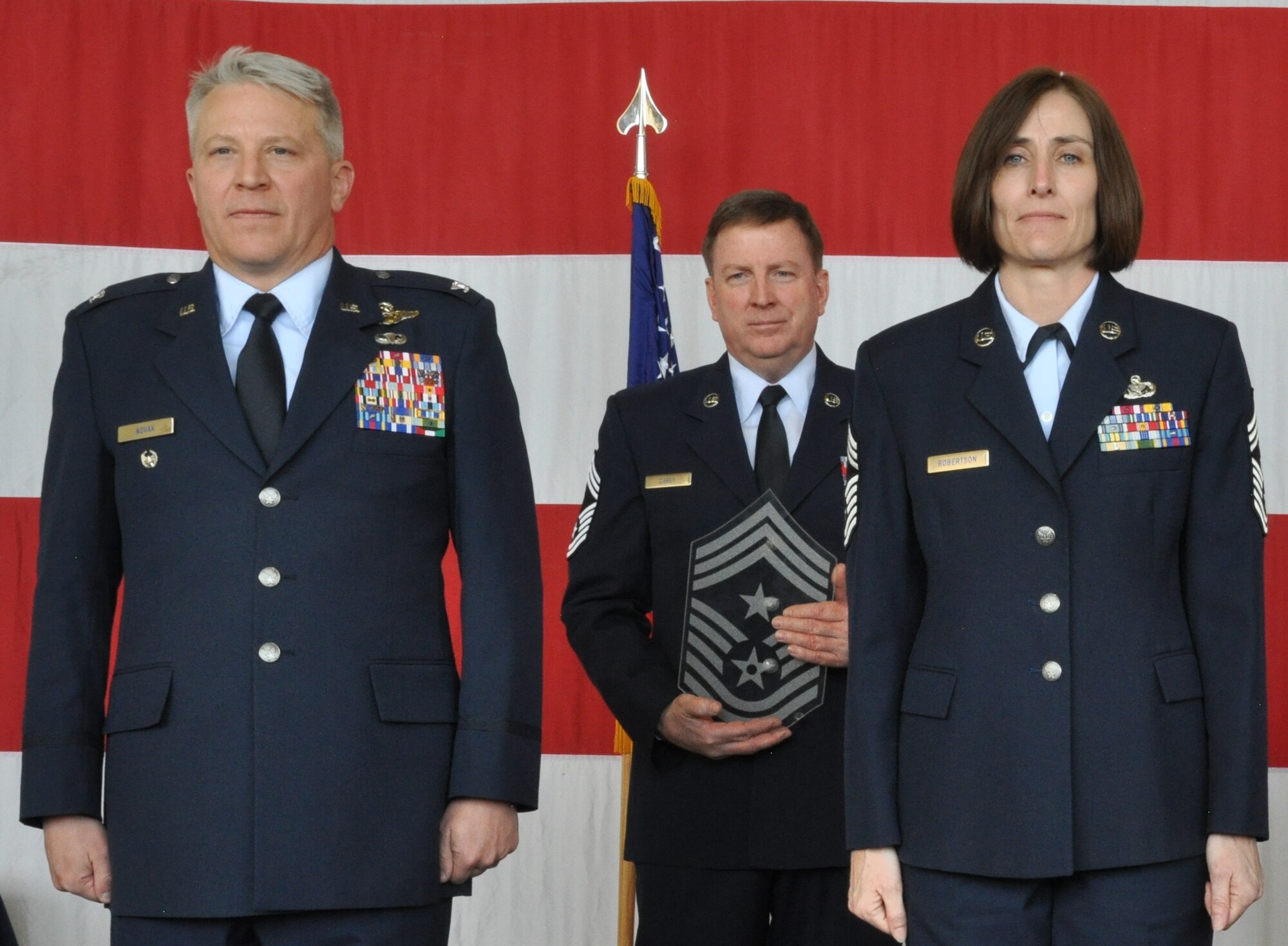 PETERSON AIR FORCE BASE, Colo. – Col. Erich Novak, 302nd Airlift Wing vice commander, and Chief Master Sgt. Vicki Robertson face the audience moments after Robertson was named the 302nd AW command chief during a ceremony here April 3, 2016. The announcement of Robertson’s selection to the position was made during change of responsibility ceremony where former 302nd AW Command Chief Master Sgt. Otis Jones relinquished responsibility to Robertson. Chief Master Sgt. Dave Carey, center, acted served as the proffer for the ceremony. (U.S. Air Force photo/2nd Lt. Stephen Collier)