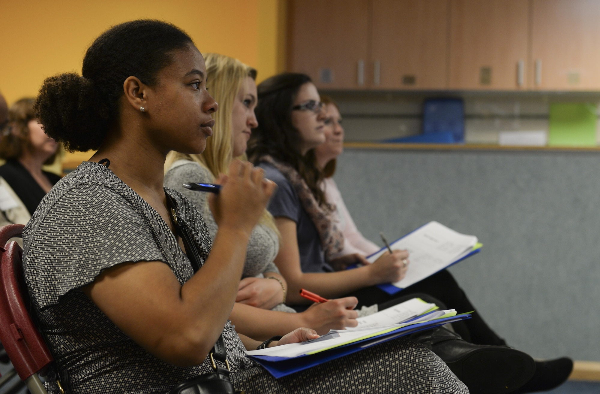 Participants in the 2016 Child and Youth Programs Training Conference for the U.K. take notes during the Prop Box class Sept. 10, 2016, on RAF Mildenhall, England. Approximately 130 childcare providers from RAF Mildenhall, RAF Lakenheath, RAF Croughton and RAF Alconbury attended and participated in 27 classes. The event enabled individuals to receive up to six hours of training to go toward their annually required 24 training hours. (U.S. Air Force photo by Staff Sgt. Micaiah Anthony)
