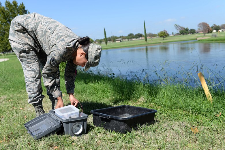 Airman 1st Class Robin Brown, 47th Medical Group public health technician, assembles a mosquito trap on Laughlin Air Force Base, Texas, Sept. 8, 2016. The specialized trap captures samples that are sent to a lab for examination. (U.S. Air Force photo Airman 1st Class Benjamin N. Valmoja)