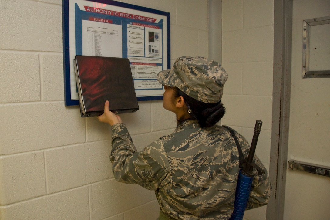 3rd WOT Trainee conducting entry controller duties as she verifies dormitory access procedures.