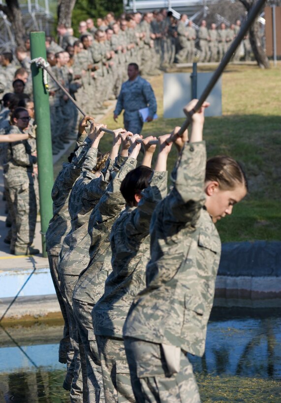 4th WOT Trainees crossing a water obstacle at the obstacle course.