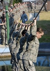 4th WOT Trainees crossing a water obstacle at the obstacle course.