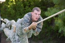 4th WOT Focusing on crossing a water hazard using a rope at the obstacle course.