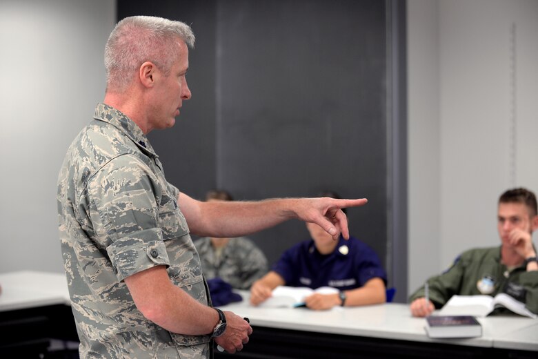 Lt. Col. Bill Uhl, an assistant professor and deputy head of the Philosophy Department at the U.S. Air Force Academy, speaks to cadets in a classroom, Sept. 8, 2016. Uhl suffers from hearing loss but says his qualify of life has greatly improved by the use of hearing aids and assisstive listening technology. (U.S. Air Force photo/Darcie Ibidapo)