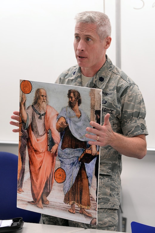 Lt. Col. Bill Uhl, an assistant professor and deputy head of the Philosophy Department at the U.S. Air Force Academy, speaks to cadets in a classroom, Sept. 8, 2016. Uhl suffers from hearing loss but says his qualify of life has greatly improved by the use of hearing aids and assisstive listening technology, which he wears while teaching class. (U.S. Air Force photo/Darcie Ibidapo)