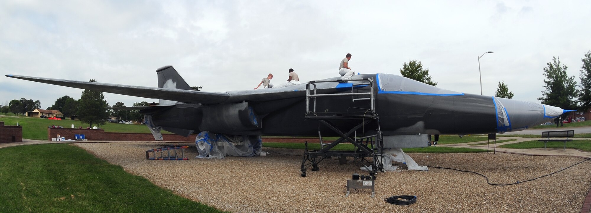 Low observable technicians from the 509th Maintenance Squadron tape off sections of an FB-111A General Dynamics Aardvark static display prior to repainting it at Whiteman Air Force Base, Mo., Sept. 13, 2016. During the restoration process, the aircraft was sanded, primed, repainted and received corrosion maintenance. (U.S. Air Force photo by Senior Airman Joel Pfiester)