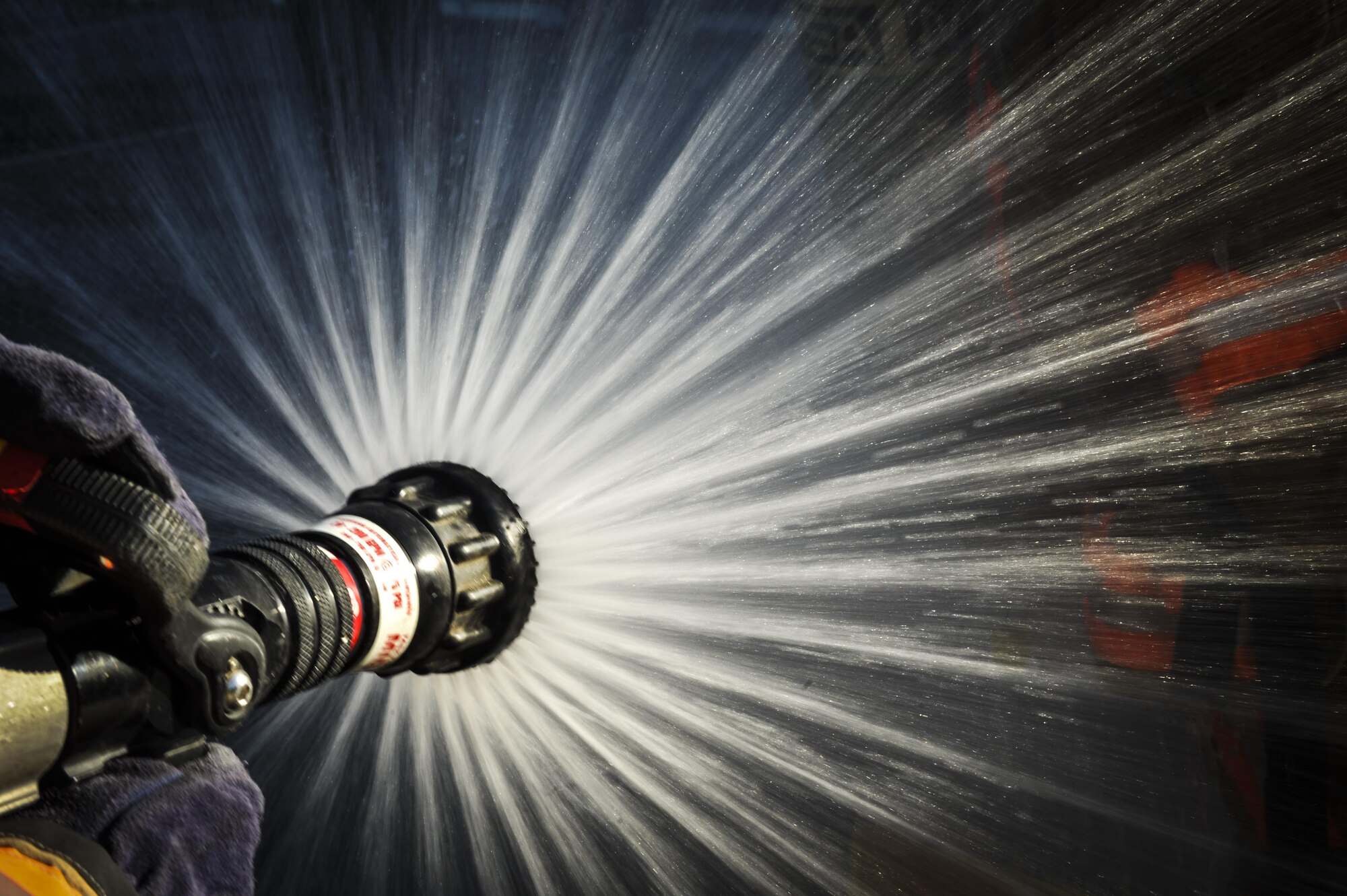 Airman 1st Class Chad Blakely, a firefighter with the 1st Special Operations Civil Engineering Squadron, hoses down Air Commandos during an exercise at Hurlburt Field, Fla., Sept. 15, 2016. The 1st Special Operations Wing conducted a three-day exercise to ensure personnel are update to date on emergency response procedures. (U.S Air Force photo by Airman 1st Class Joseph Pick)