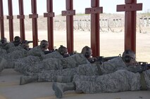 5th WOT Trainees demonstrate the prone firing position at live fire course.