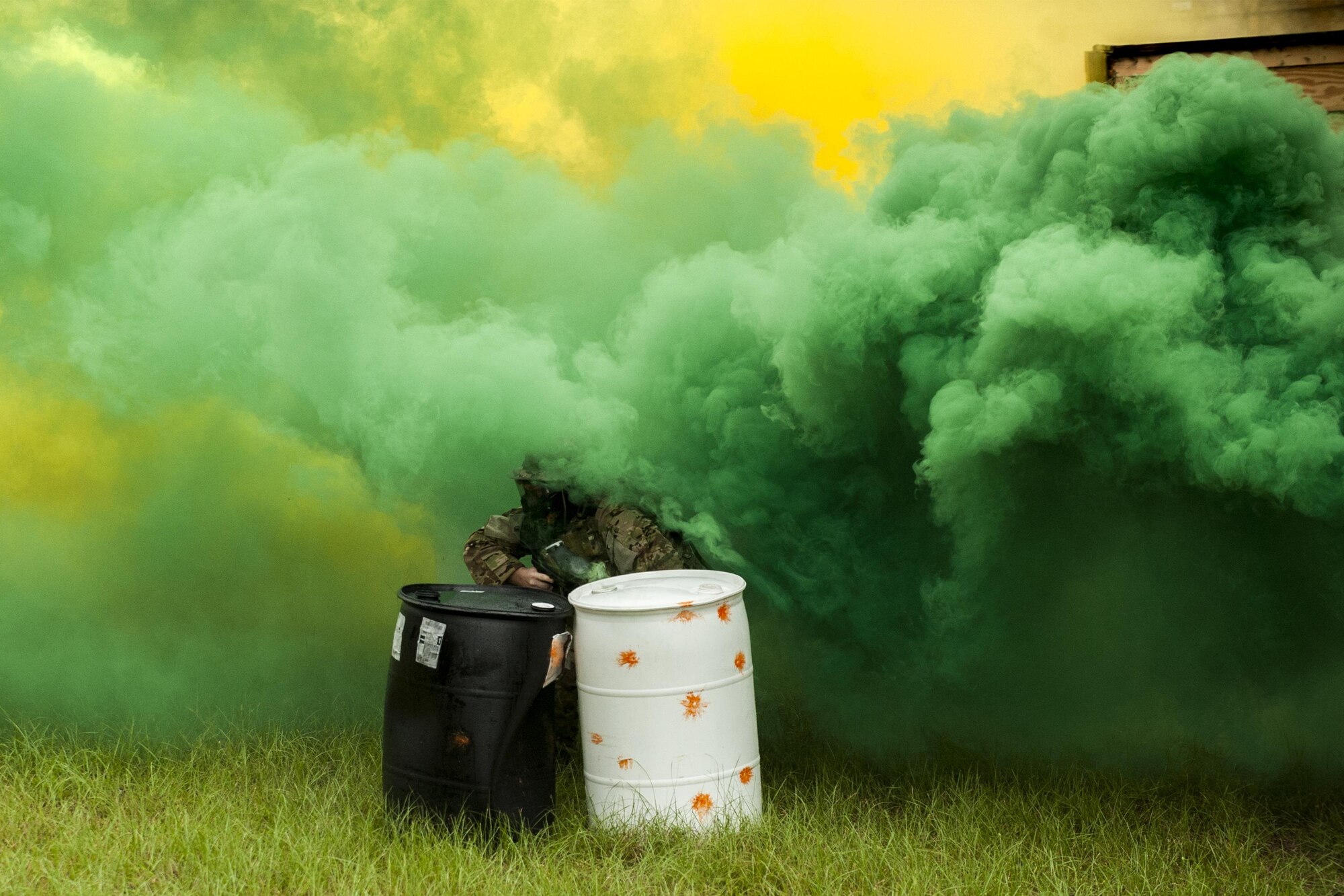 U.S. Air Force Tech. Sgt. Anthony Del Vecchio,   41st Rescue Squadron NCO in charge of weapons and tactics, takes cover provided by smoke grenades during combat survival training, Sept. 13, 2016, at Moody Air Force Base, Ga. Every 36 months aircrew members are required to complete CST to stay current with their survivability skills in high-threat environments. (U.S. Air Force photo by Airman 1st Class Daniel Snider)