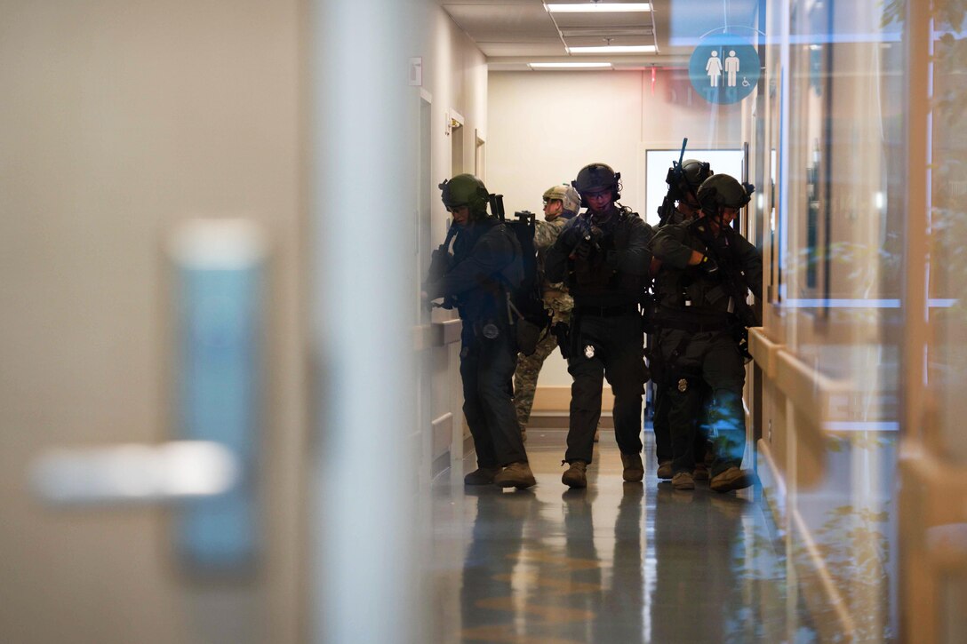 Soldiers check doors while searching a hallway for mock suspects during a training exercise at the Fort Belvoir Community Hospital at Fort Belvoir, Va., Sept. 13, 2016. The soldiers are Special Reaction Team members assigned to the 289th Military Police Company of the 3rd U.S. Infantry Regiment, known as "The Old Guard." Army photo by Sgt. Cody W. Torkelson