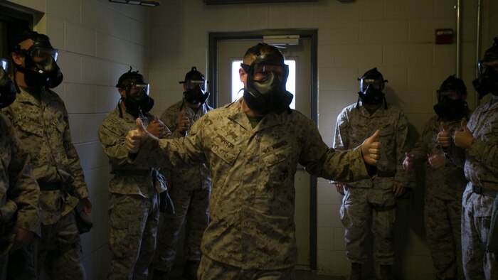 Cpl. Austin Potts, Chemical, Biological, Radioactive and Nuclear defense specialist, Headquarters and Service Battalion, Marine Corps Security Force Regiment, asks Marines to give a “thumbs-up” signal to signify they are ready for exposure to the compound 2-chlorobenzalmalonitrile, or CS gas, aboard Naval Station Norfolk, Va., Sept. 15, 2016. The Marines spent two days learning about CBRN defenses and concluded their training in the gas chamber as part of their annual qualification. 