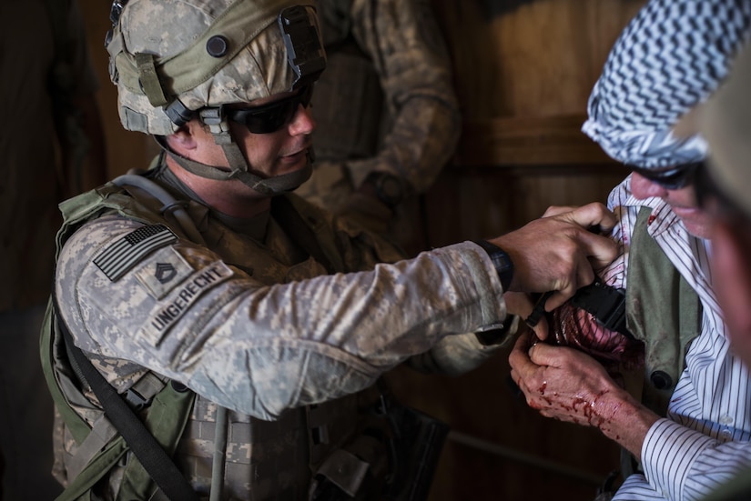 Sgt. 1st Class Derek Ungerecht, a civil affairs Soldier from Chesapeake, Va., assigned to the 437th Civil Affairs Battalion, puts a tourniquet on a role player simulating an injury during training at National Training Center Fort Irwin, Calif., Sept. 7, 2016. The 437th Civil Affairs Bn. keeps troops trained and proficient in order to support the s 352nd Civil Affairs Command’s mission to support the Central Command area of operations. (U.S. Army photo by Master Sgt. Mark Burrell, 352nd CACOM)