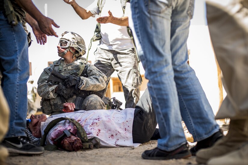 Spc. Madelyn Riccio, a civil affairs Soldier from Virginia Beach, Va., assigned to the 437th Civil Affairs Battalion, puts a tourniquet on a role player simulating an injury during training at National Training Center Fort Irwin, Calif., Sept. 7, 2016. The 437th Civil Affairs Bn. keeps troops trained and proficient in order to support the s 352nd Civil Affairs Command’s mission to support the Central Command area of operations. (U.S. Army photo by Master Sgt. Mark Burrell, 352nd CACOM)