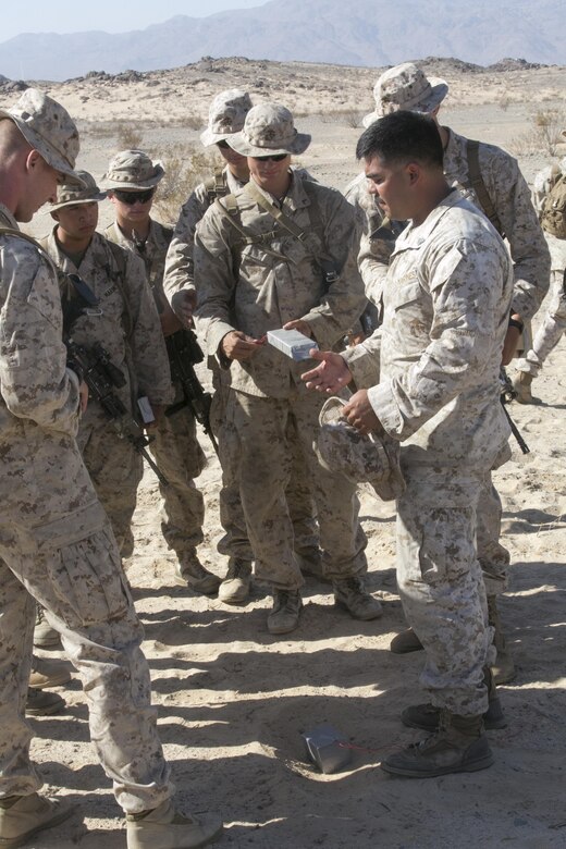 Marines with Company A, 3rd Light Armored Reconnaissance Battalion, review the concepts of planting Improvised Explosive Devices at Range 100 aboard Marine Corps Air Ground Combat Center, Twentynine Palms, Calif., Sept. 8, 2016. During the training, the Marines practiced a variety of exercises to include patrolling, land navigation as well as planting and locating improvised explosive devices. (Official Marine Corps photo by Cpl. Thomas Mudd/Released)