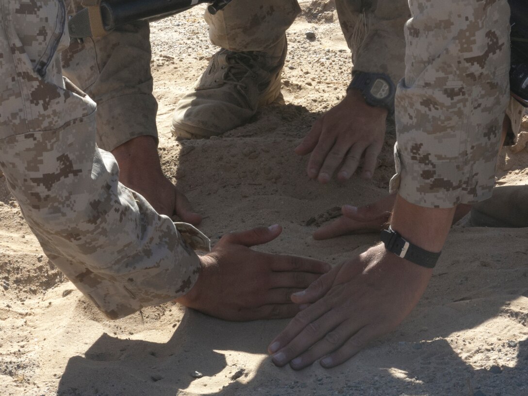 Marines with Company A, 3rd Light Armored Reconnaissance Battalion, bury simulated Improvised Explosive Devices at Range 100 aboard Marine Corps Air Ground Combat Center, Twentynine Palms, Calif., Sept. 8, 2016. The training prepared the company to be the opposing force for 3rd LAR, Company C. (Official Marine Corps photo by Cpl. Thomas Mudd/Released)
