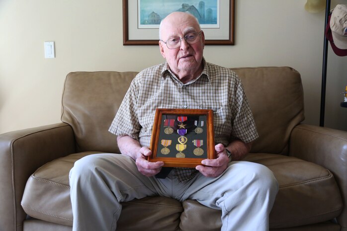 Former Marine Sgt. Warren Jorgenson, 96, holds the medals he was awarded during World War II, where he was taken by Japanese soldiers as a prisoner of war. Jorgenson spent years as prisoner before being liberated in September 1945. (U.S. Marine Corps photo by Cpl. Jennifer Webster/Released)