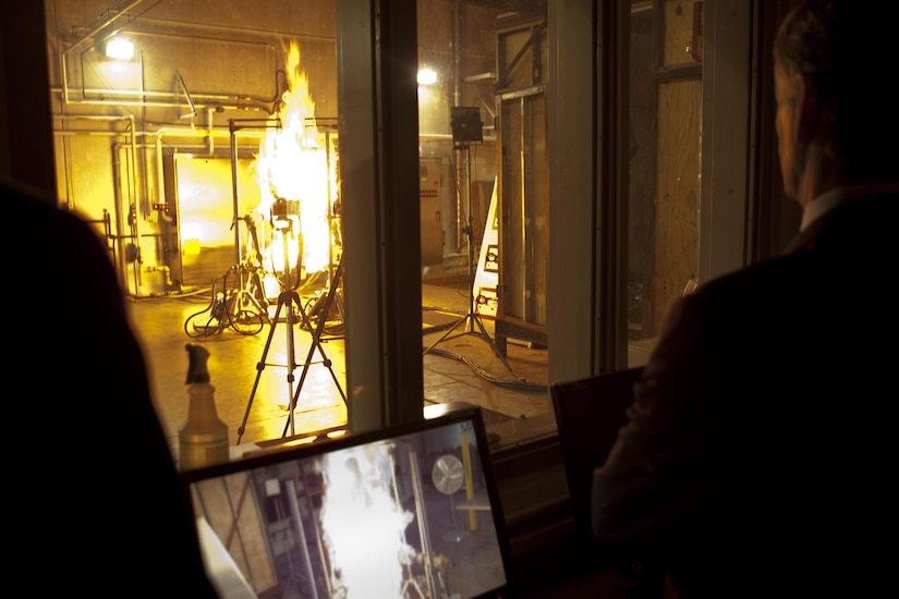 Secretary of the Army John McHugh observes one of the tests used to determine fire-resistant properties of textiles during a visit to the Ouellette Thermal Test Facility, Natick Soldier Systems Center, Natick, Mass., March 15, 2012. Tests such as this have contributed to the development of improved clothing and individual equipment to protect soldiers. Army photo by Spc. John G. Martinez