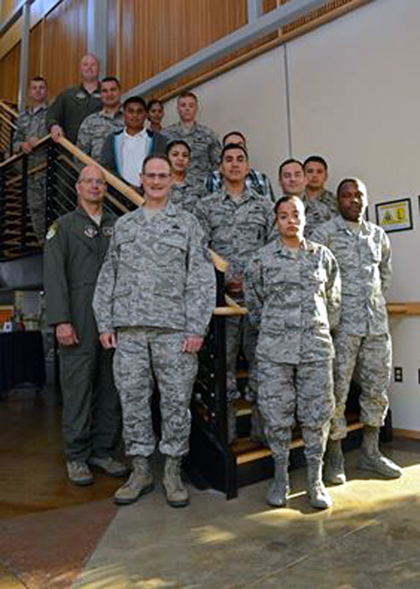 The newest members of the 349th Air Mobility Wing pose for a photo with Col. Raymond A. Kozak, 349th AMW commander (lower left) and Chief Master Sgt. Bryan A. Payne, 349th AMW command chief master sergeant, at Travis Air Force Base, Calif., Sept. 10, 2016.