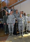 The newest members of the 349th Air Mobility Wing pose for a photo with Col. Raymond A. Kozak, 349th AMW commander (lower left) and Chief Master Sgt. Bryan A. Payne, 349th AMW command chief master sergeant, at Travis Air Force Base, Calif., Sept. 10, 2016.