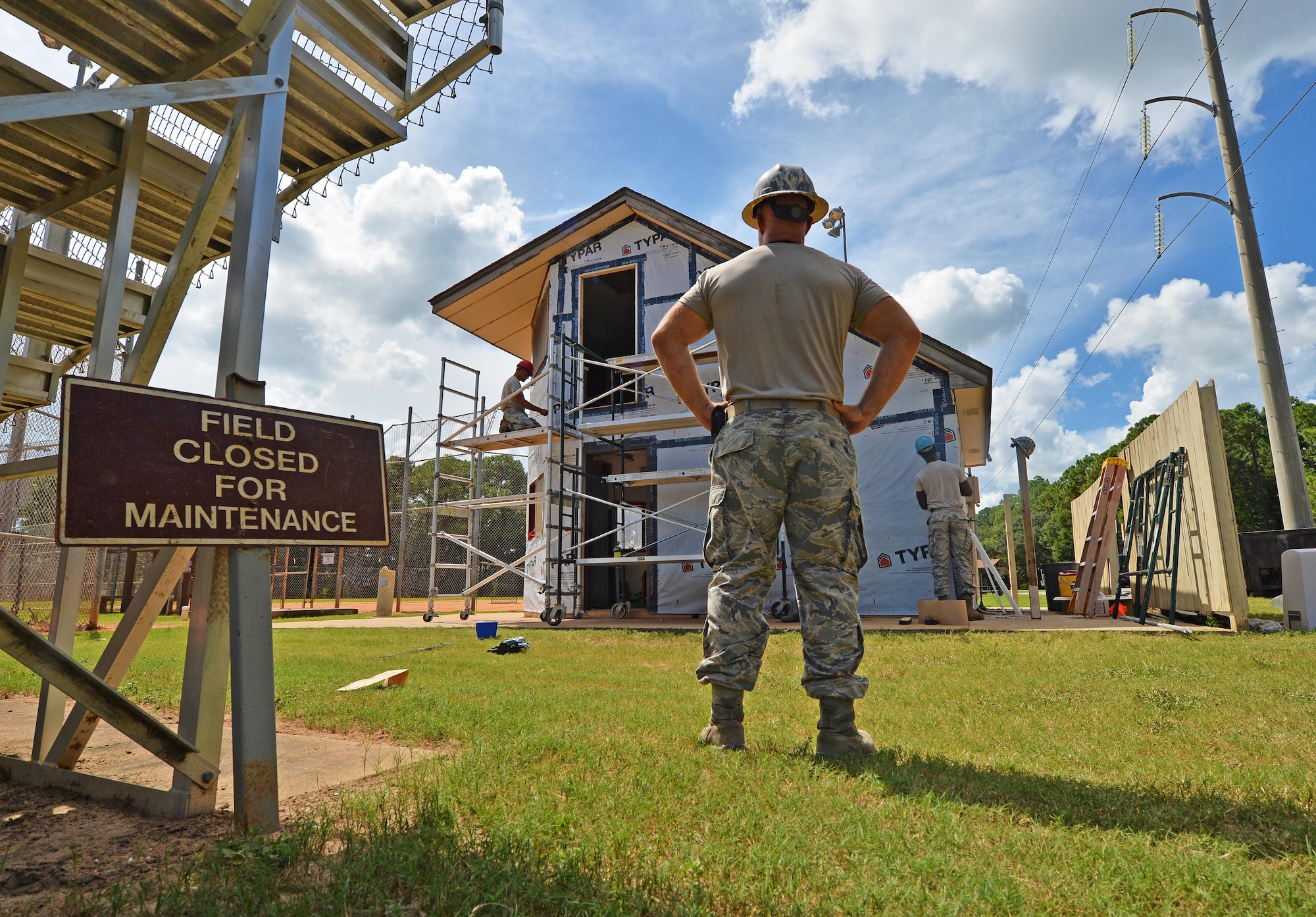 Tech. Sgt. Rickey Schaefer, a structural journeyman with the 556th RED HORSE, surveys the project area as his wingmen renovate the softball field press box at Hurlburt Field Fla., Sept. 13, 2016. The team of craftsman, a blend of reservists from the 556th and 1st Special Operations Civil Engineering Squadron Airmen, renovated the building using funds from the Installation Excellence Award. The $200,000 award is being used to invest resiliency in the force and family by renovating community buildings used for moral events. (U.S. Air Force photo by Senior Airman Andrea Posey)