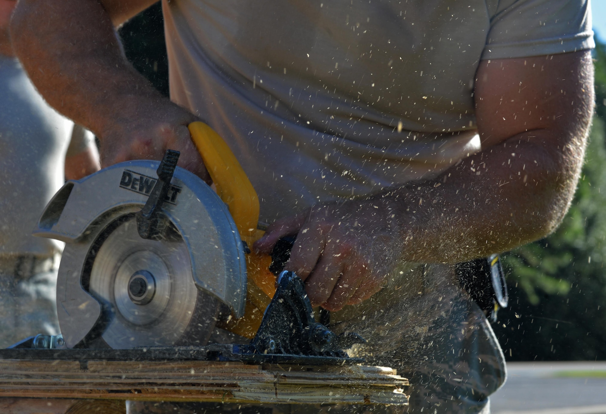 Tech. Sgt. Rickey Schaefer, a structural journeyman with the 556th RED HORSE, cuts planks of wood with a buzz saw during the renovation of the softball field press box at Hurlburt Field Fla., Sept. 15, 2016. These planks are used as exterior walls for the softball field press box. (U.S. Air Force photo by Senior Airman Andrea Posey)