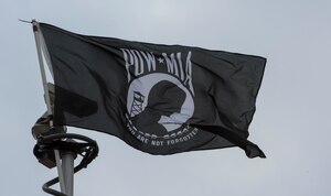 A POW/MIA flag blows in the wind amidst a POW/MIA Recognition Event ceremony and run at Joint Base Andrews, Md., Sept. 15, 2016. The event began with an opening ceremony and a perimeter run led by leadership from seven different base organizations. Following the approximately nine-mile run, various units participated in a section of a continual 24-hour run to remember the sacrifices and service many military members who were imprisoned while serving and those who remain missing. (U.S. Air Force photo by Senior Airman Jordyn Fetter)