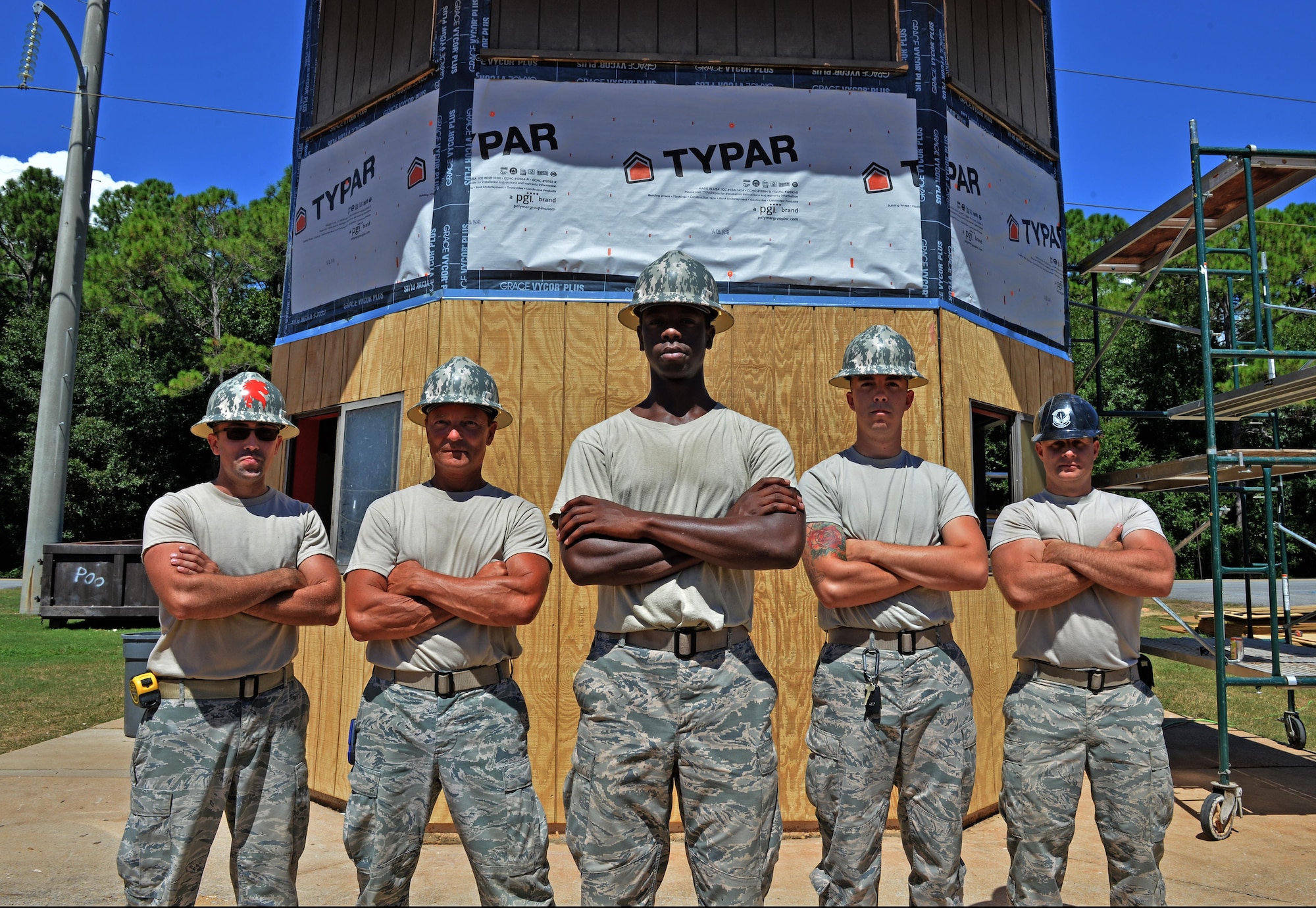 Airmen from the 556th RED HORSE and the 1st Special Operations Civil Engineering Squadron stand in front of the softball field press box at Hurlburt Field Fla., Sept. 15, 2016. Structural specialists are renovating the press box to repair moisture damage in the exterior and interior walls. (U.S. Air Force photo by Senior Airman Andrea Posey)