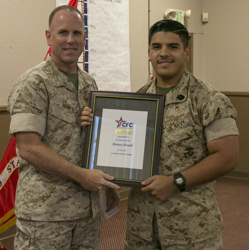 Col. James Harp, Combat Center Chief of Staff, presents 23rd Dental Company, 29 Palms the Bronze Award during the Combined Federal Campaign Kick-off luncheon at Frontline Restaurant, Sept. 9, 2016. The CFC gives the Bronze Award when a unit has had 50 to 60 percent participation or $50 to $65 per capita giving. (Official Marine Corps photo by Lance Cpl. Dave Flores/Released)
