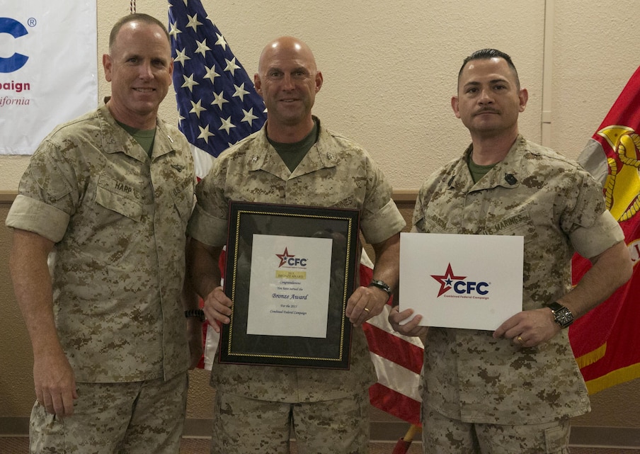 Col. James Harp, Combat Center Chief of Staff, presents the Marine Corps Logistics Operations Group the Bronze Award during the Combined Federal Campaign Kick-off luncheon at the Frontline Restaurant, Sept. 9, 2016. The CFC gives the Bronze Award when a unit has had 50 to 60 percent participation or $50 to $65 per capita giving.  (Official Marine Corps photo by Lance Cpl. Dave Flores/Released)