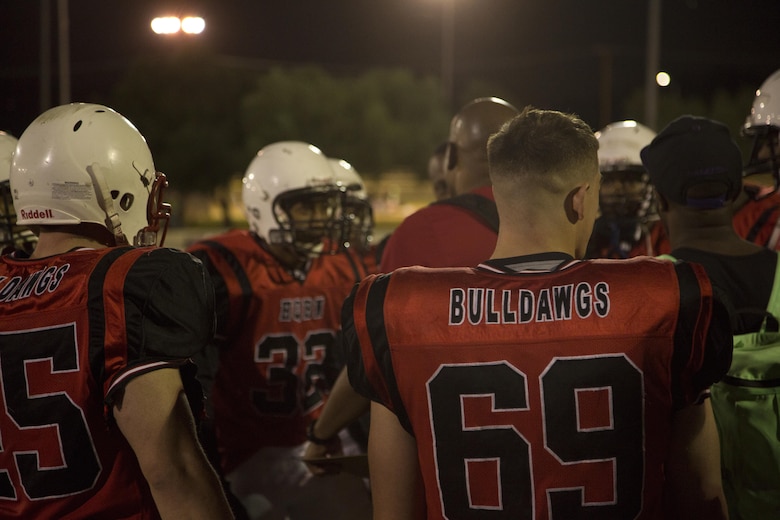 Marines from the Headquarters Battalion football team gather for a motivational talk during the Marine Corps Community Services Sports hosted Football Jamboree at Felix Field, Sept. 14, 2016. The event is held annually and functions as a pre-season game for the Intramural Tackle Football League. (Official Marine Corps photo by Cpl. Medina Ayala-Lo/Released)