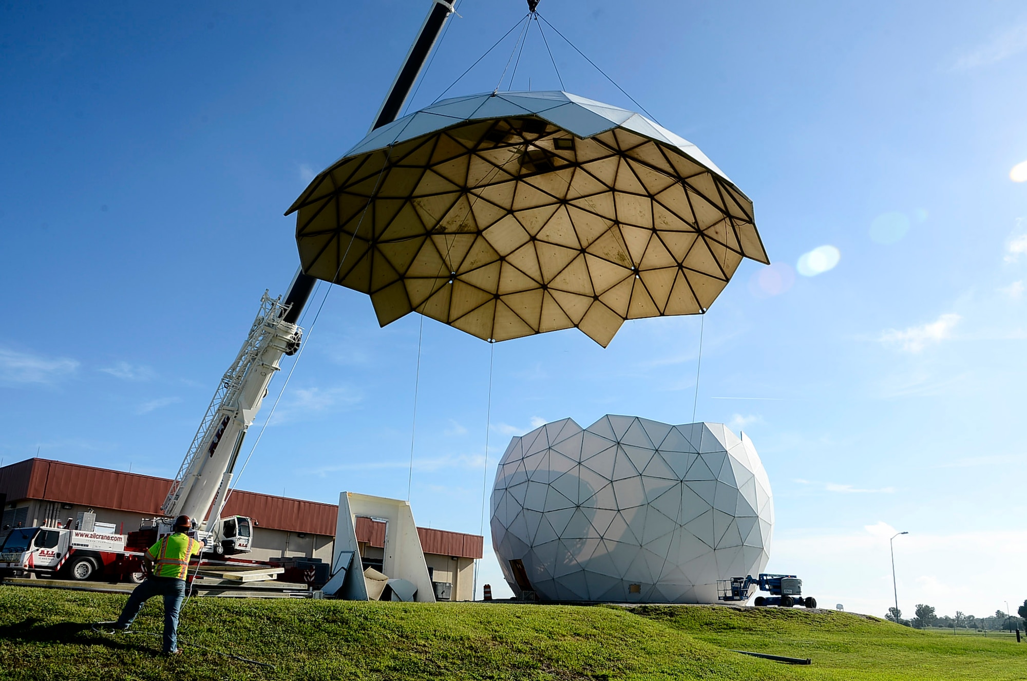 Contractors remove the top of the radome, otherwise known as the "Golf Ball," during its deconstruction at MacDill Air Force Base. Fla., Sept. 12, 2016. The golf ball and satellite are scheduled to be completely torn down by Sept. 21, 2016. (U.S. Air Force photo by Senior Airman Tori Schultz)