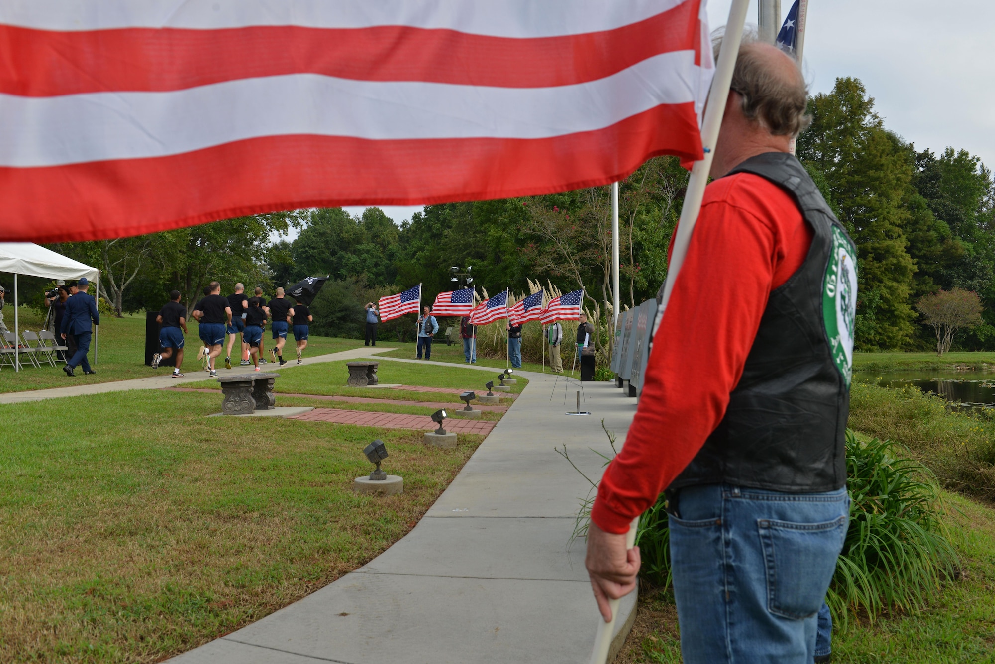 Veterans hold American flags during a National POW/MIA Recognition Day vigil run at Shaw Air Force Base, S.C., Sept. 16, 2016. Military members, veterans and community leaders were invited to a ceremony to honor and recognize the sacrifices made by POW/MIAs. (U.S. Air Force photo by Airman 1st Class Destinee Sweeney)