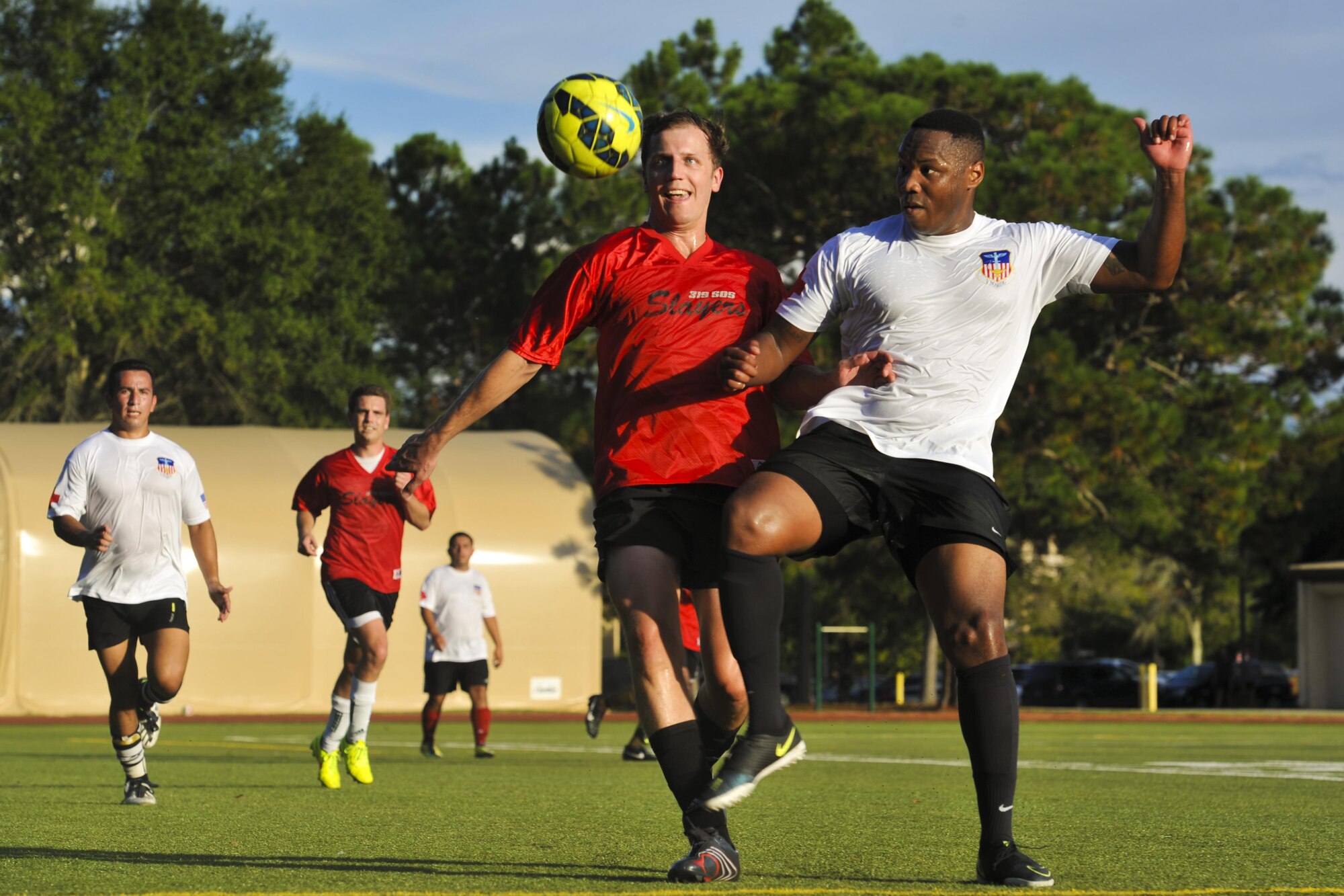 Members of 1st Special Operations Medical Group and the 319th Special Operations Squadron’s intramural soccer teams fight for the soccer ball at Hurlburt Field, Fla., Sept. 13, 2016. The 1st SOMDG won the 2016 Intramural Soccer Championship after a double-elimination match-up. (U.S. Air Force photo by Airman Dennis Spain)
