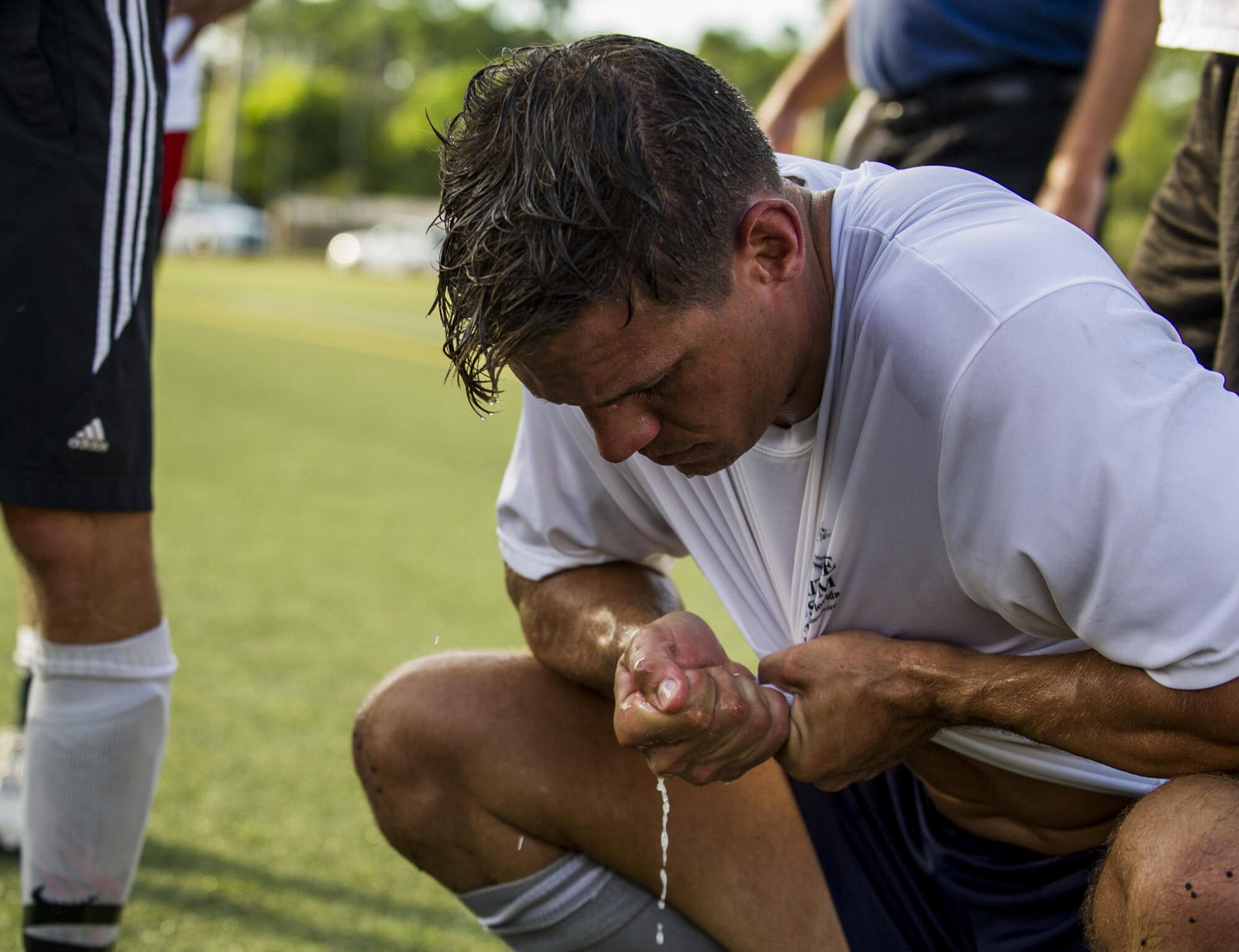 Shawn Winkeler, a member of the 1st Special Operations Medical Group intramural soccer team, wrings out his shirt at halftime during the 2016 Intramural Soccer Championship against the 319th Special Operations Squadron at Hurlburt Field, Fla. Sept. 13, 2016. The 1st SOMDG defeated the 319th SOS in a double-elimination match with a final score of 2-0. (U.S. Air Force photo by Airman 1st Class Isaac O. Guest IV)
