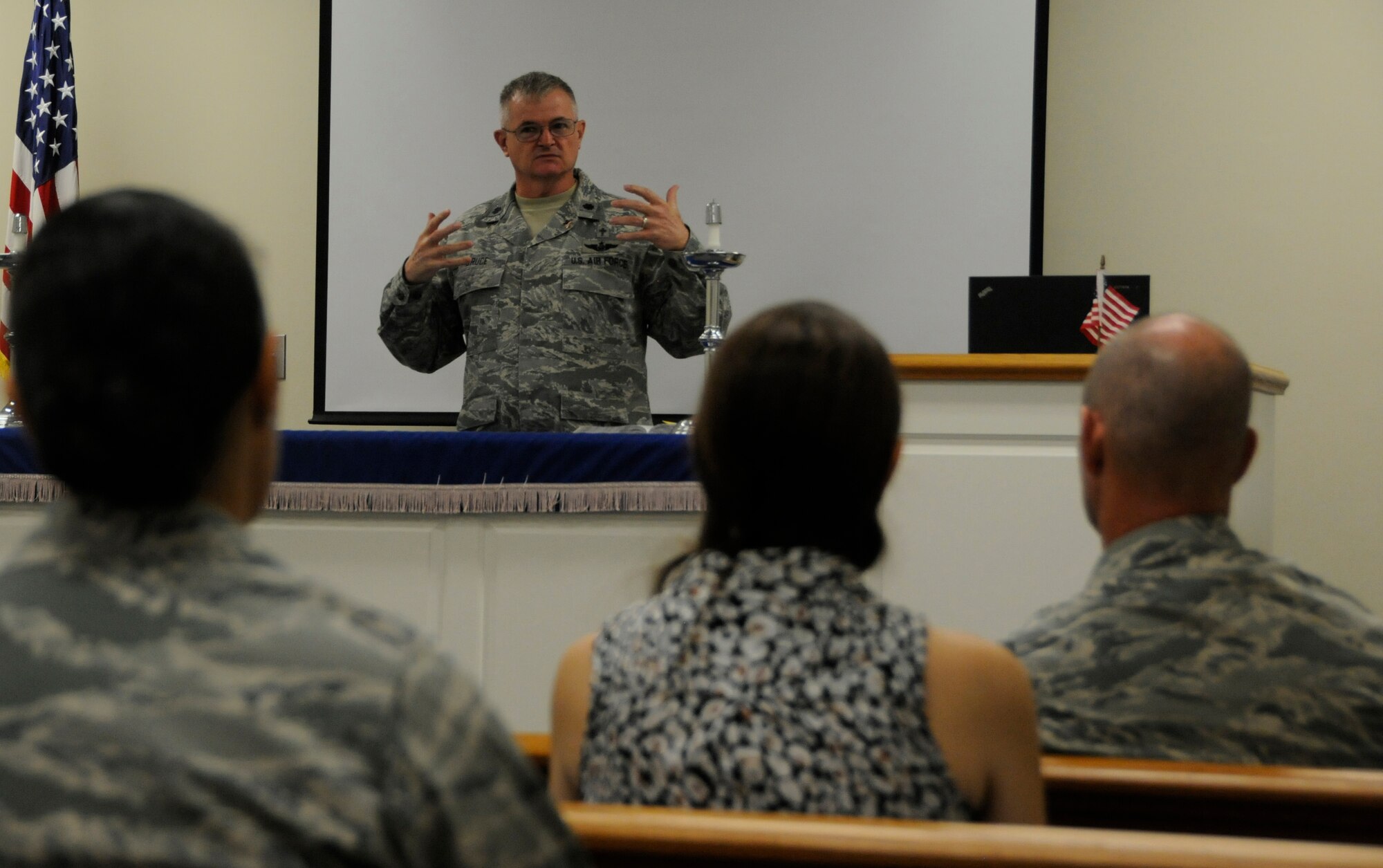 Chaplain (Lt. Col.) Jeffery Bruce speaks to a group of Airmen about being watchmen during a 9/11 remembrance service in the base chapel Sept. 11. The service was held to honor the 2, 996 victims killed in the 9/11 terrorist attacks. (U.S. Air Force photo by Senior Airman Aja Heiden)